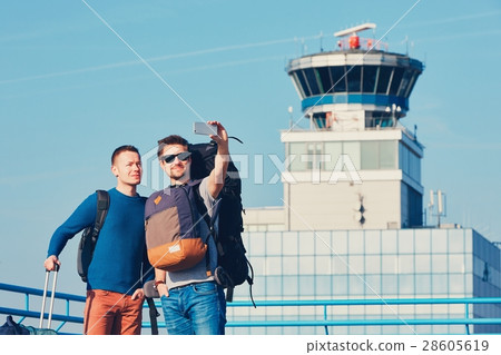 Travelers taking a selfie at the airport 28605619