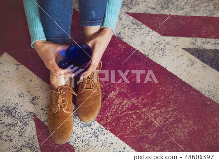 Cup of tea in hands of the woman Cup of tea in hands of the woman 28606397