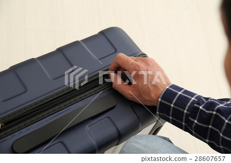 Male hand to open suitcase Male hand to open suitcase 28607657