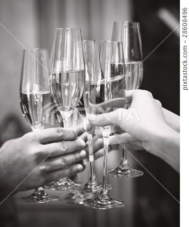 People holding glasses of champagne making toast. 28608496