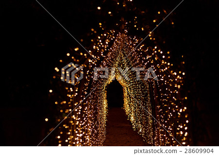 Path under the arch of yellow lamps leads through Path under the arch of yellow lamps leads through 28609904