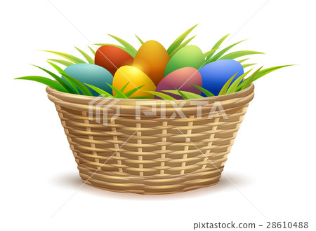 Wicker basket full of Easter eggs on grass 28610488