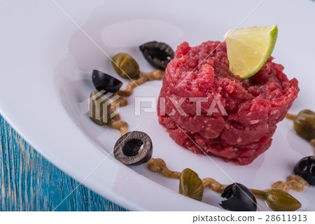 Single portion of tartar steak on white plate Single portion of tartar steak on white plate 28611913