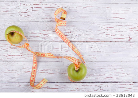 The centimeter stands near green apples The centimeter stands near green apples 28612048