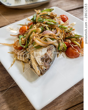 Salted fish fried topped with red onion, chili 28612153