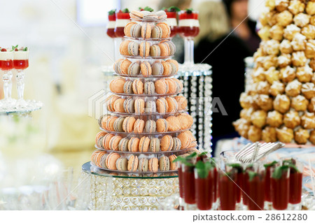 Orange and violet macaroons served as a pyramid  28612280