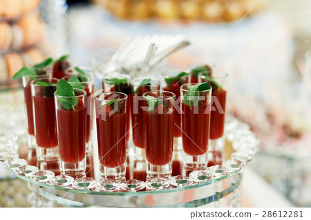 Glasses with berry drinks stand served  28612281