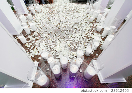 Look from above at tall vases with white candles  28612403