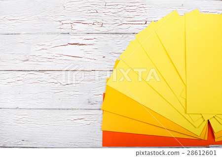 Papers in shades of orange and yellow lie Papers in shades of orange and yellow lie 28612601