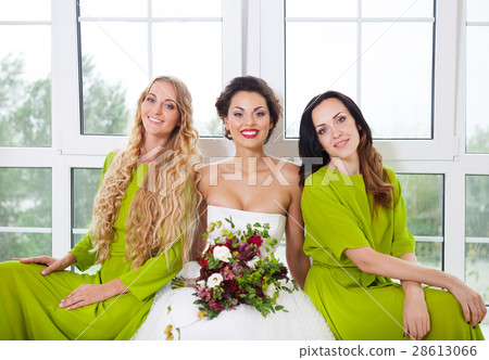 Cheerful bride with female friends 28613066