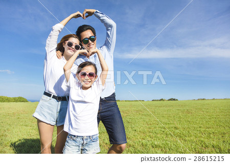 Happy playful young family forming love shape Happy playful young family forming love shape 28615215