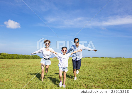 Happy family running together on the grass Happy family running together on the grass 28615218