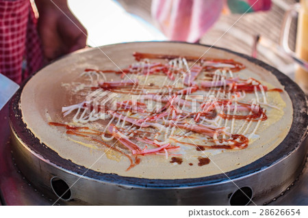 Freshly made Crepe on a hot plate. Freshly made Crepe on a hot plate. 28626654