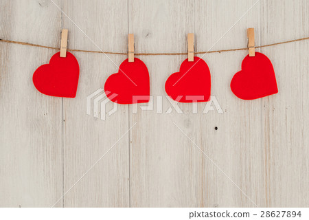 Red heart hanging on the clothesline. On old wood 28627894