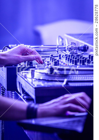 In the hands of the DJ. Dj hands on mixer. In the hands of the DJ. Dj hands on mixer. 28628778