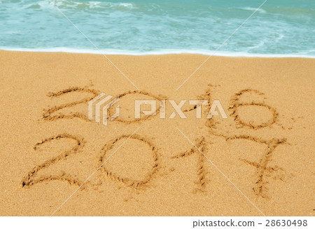 digits 2016 and 2017 on the sand digits 2016 and 2017 on the sand 28630498