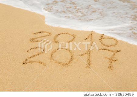digits 2016 and 2017 on the sand digits 2016 and 2017 on the sand 28630499