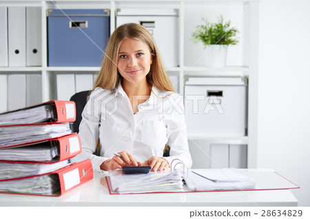 Business woman calculates tax Business woman calculates tax 28634829