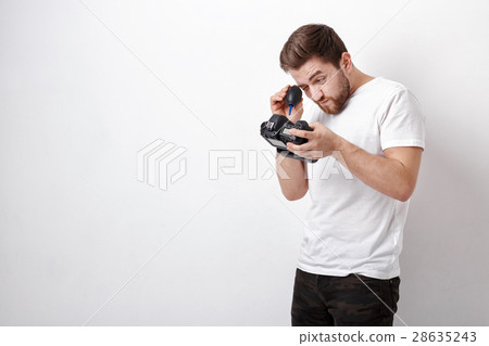 photographer cleaning camera with vacuum pump 28635243