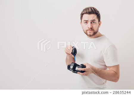 photographer cleaning camera with vacuum pump 28635244