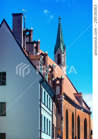 Green cockerel and old church 28636863