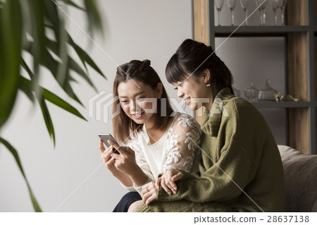A woman watching a smartphone 28637138