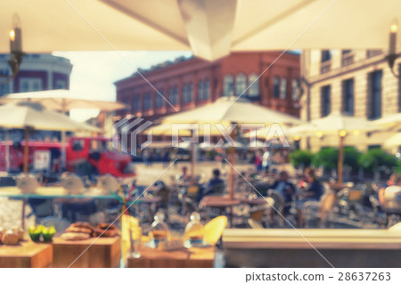 Umbrellas outdoor cafes and tourists. Blurrry 28637263