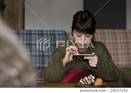 Women taking food pictures Women taking food pictures 28637292