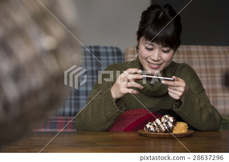 Women taking food pictures 28637296