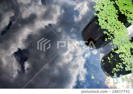 Skyscrapers and clouds reflected in the water Skyscrapers and clouds reflected in the water 28637742