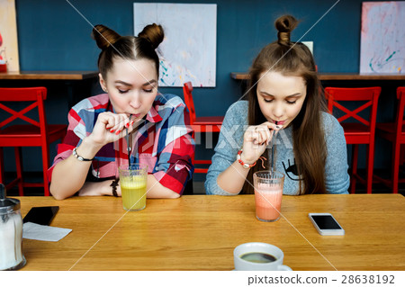 Young girls having fun in a cafe bar Young girls having fun in a cafe bar 28638192