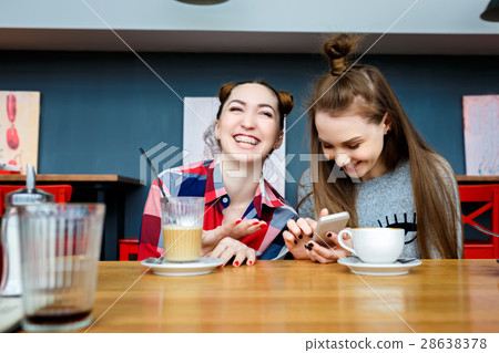 two young beautiful hipster women sitting at cafe two young beautiful hipster women sitting at cafe 28638378