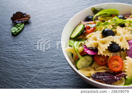 Pasta salad made from farfalle, onion, tomatoes 28639079