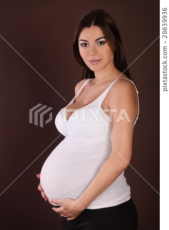Happy pregnant woman touching her belly Happy pregnant woman touching her belly 28639936