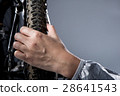 Hand cheking tyre pressure. 28641543
