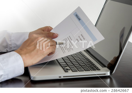 job seeker review his resume on his desk job seeker review his resume on his desk 28642667