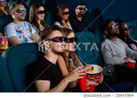 Lovely young couple on a date at the cinema Lovely young couple on a date at the cinema 28643904