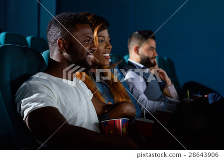Happy African couple at the cinema Happy African couple at the cinema 28643906