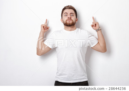 handsome man with beard pointing up. young man 28644236