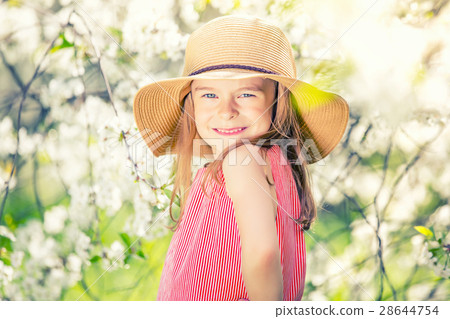 Happy little girl in cherry blossom garden Happy little girl in cherry blossom garden 28644754