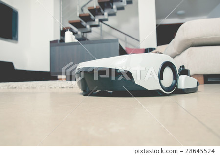 Robot vacuum cleaner working in modern home 28645524