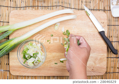 Chef putting slice of scallion to cup Chef putting slice of scallion to cup 28646829