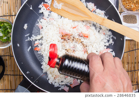 Chef putting soy sauce for cooking rice Chef putting soy sauce for cooking rice 28646835