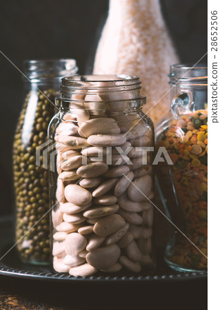 Rice, lentils, white beans in bottles side view 28652506