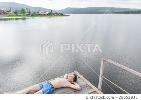 Young boy relaxes Young boy relaxes 28652933