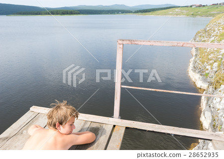 Young boy relaxes Young boy relaxes 28652935