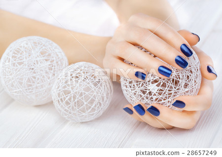 blue manicure with a white ball of yarn blue manicure with a white ball of yarn 28657249