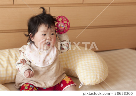 baby holding cushion