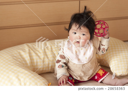 baby holding cushion