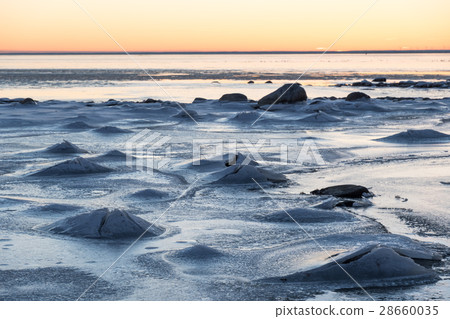 Sunset view at an ice covered coastline 28660035